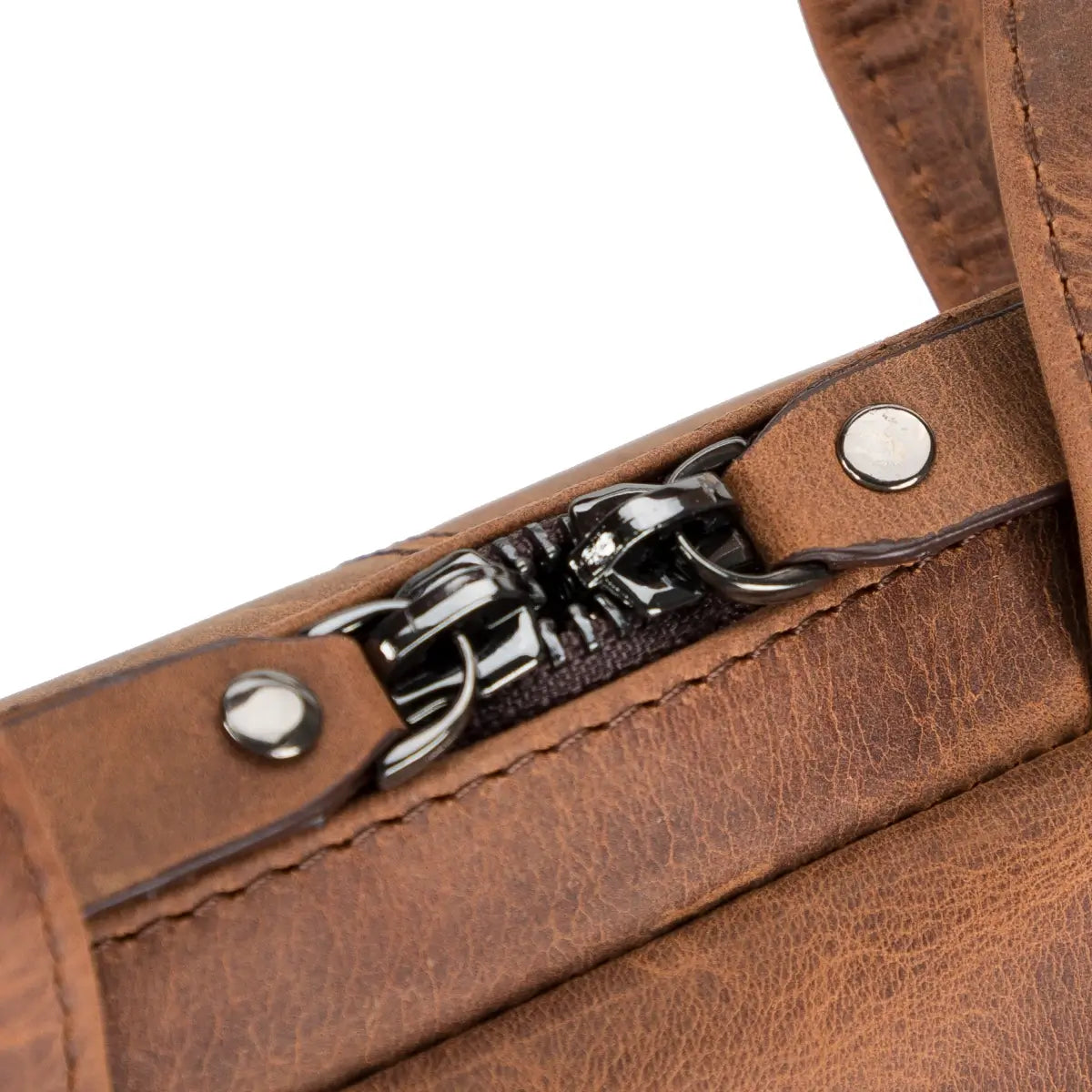 Close-up of a brown leather briefcase with a metal pull.