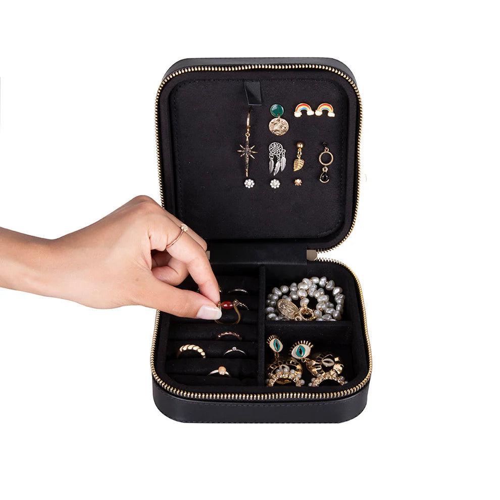 Black leather jewelry box with various earrings